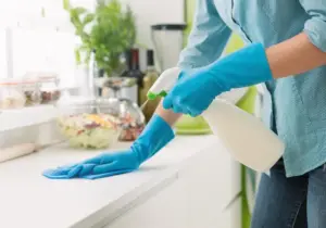 woman cleaning a counter top