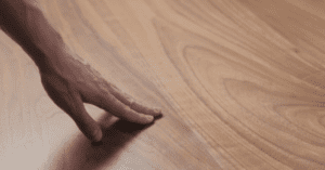 hand touching wooden floor